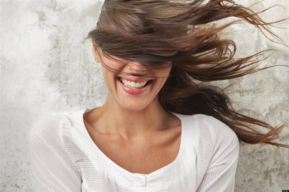 A smiling girl with disheveled hair